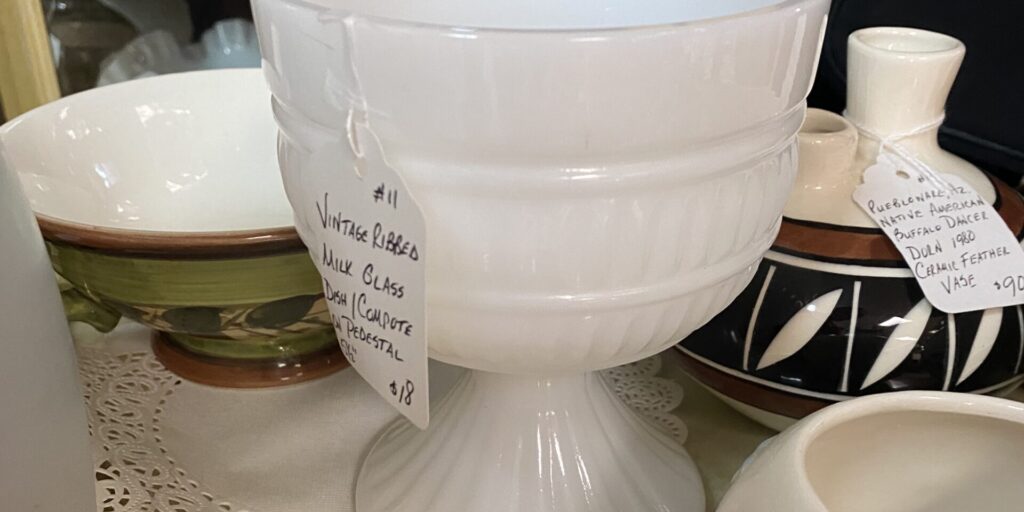 a piece of vintage milk glass on a shelf at Salt River Antiques in St Marys, Georgia